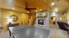 As you enter, there is a table tennis table, situated in the center of the room, ready for a friendly match or a lively competition. The space around it is open, allowing for plenty of room to move, serve, and dive for the ball.
