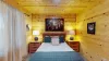 On both sides of the bed there is nightstands with lamps to give the room more light.