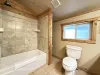 Private master bathroom has a tub and shower combo.
