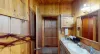 Bathroom located in the first door of the hallway.