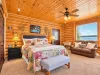 Master bedroom with a king size bed and sitting area overlooking the lake.