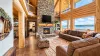 Living room is equipped with a beautiful fireplace, tv for entertainment, and plenty of seating for everyone.