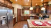 Beautiful kitchen equipped with stainless steel appliances, pots and pans, dishes, silverware, and basic cooking essentials.