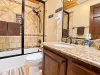 2nd bathroom downstairs with shower/tub combo, toilet, and sink vanity.