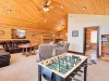 Upstairs loft is equipped with sectional couch, satellite tv, and foosball table.