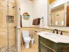 1st bathroom downstairs with walk-in shower, toilet, and sink.