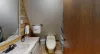 The main level has a full bathroom with a shower, toilet, and a sink vanity.