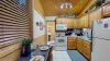 A full kitchen with appliances and dining table to enjoy.