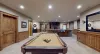 Basement living area with a pool table.
