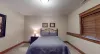 Bedroom #5 located in the basement with a Queen size bed.