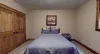 Bedroom #6 located in the basement with a Queen size bed.
