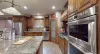 Equipped with stainless steel appliances, dishes, silverware, pots and pans, and basic cooking essentials.