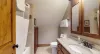 Upstairs shared bathroom with shower and tub combo, toilet, and sink vanity.