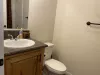 Bathroom #1 with shower tub combo, toilet, and sink vanity.