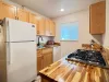 Galley kitchen with gas cook top and oven.