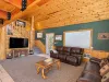 Open living room with a smart TV and games.