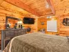 This is a spacious bedroom on the main level with a queen bed and a nook with a twin bed.