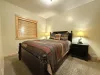 Bedroom #3 in the basement with a Queen size bed.