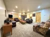 Relax after a long day in the living room that mixes both rustic charm and modern amenities.
