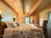 The Master bedroom is complete with two bedside tables, a lamp, and a window to enjoy your surroundings.