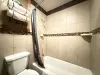 Main floor bathroom is equipped with a shower/tub, toilet, and sink vanity.