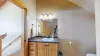 Shower tub combo, toilet, and sink vanity with storage.