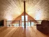 Loft with a chair and overlooks the main floor.