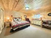Large Master bedroom with king bed and chair for reading a book