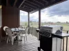 Grill and patio table on the back deck.