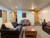As you walk down the stairs, you're greeted by warm, ambient lighting and the gentle crackle of a fireplace.