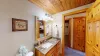 Bathroom equipped with shower tub combo, toilet, and sink vanity.