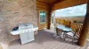 Outside deck with a grill and seating.