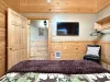 Across from the bed is a flat-screen TV—simple, unobtrusive, ready for late-night movies or quiet mornings.
