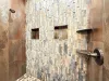 Rustic tiled master shower.