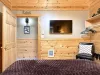Across from the bed is a flat-screen TV—simple, unobtrusive, ready for late-night movies or quiet mornings.