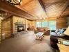 Living room on the main floor equipped with a fireplace and smart tv.