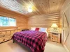 Second bedroom equipped with a king bed and dresser with a closet.