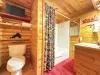 Full bathroom with tub shower combo, toilet, and sink.