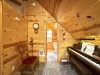 Upstairs loft corner with piano and seating.