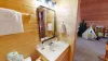 Shared upstairs bathroom with a shower tub combo, toilet, and sink vanity.