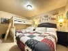 Downstairs bedroom #2, perfect for up to 5 people. This room features a queen bed and a bunk bed with a twin and double bed.