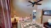 Large open bedroom that brings in lots of natural light.