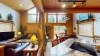 The space is flooded with natural light, thanks to large floor-to-ceiling windows that stretch across one entire wall.