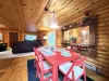 Dining room table with 6 seats and additional chairs.
