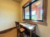 Small office with desk and beautiful window to look out of.