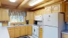 Kitchen equipped with appliances, pots and pans, dishes, utensils, and basic cooking essentials.