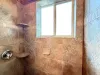 Walk in tiled shower.