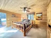 Master bedroom furnished with end stand tables, lamps, and a luggage rack.