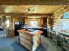 The kitchen in the cabin is a perfect blend of rustic charm and modern convenience, creating a warm and inviting space for cooking, gathering, and enjoying meals.