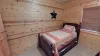 Twin bed in the kid's bedroom with a trundle bed located underneath.